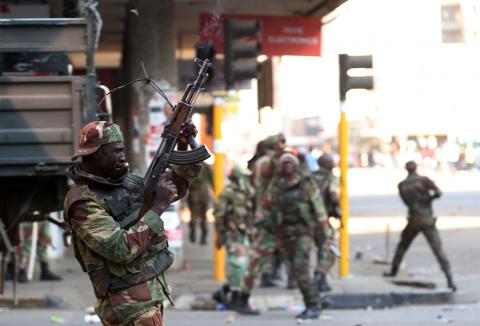 Soldiers open fire to disperse crowds of the opposition Movement for Democratic Change supporters outside the party's headquarters in Harare, Zimbabwe, August 1, 2018. PHOTO BY REUTERS/Mike Hutchings