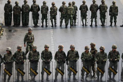 Soldiers take position along roads blocked around the Victory Monument, where anti-coup protesters were gathering on previous days, in Bangkok