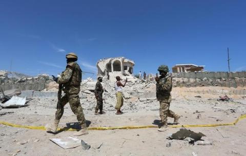 Ugandan soldiers serving in the African Union Mission in Somalia (AMISOM) walk at the scene of an explosion after a suicide attack at a checkpoint outside the main base of an African Union peacekeeping force in the Somali capital Mogadishu, January 2, 2017. PHOTO BY REUTERS/Feisal Omar