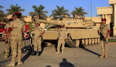 Egyptian army soldiers with a tank stand guard in front of the main gate at the Borg El Arab "Army Stadium" before the Egyptian Premier League derby soccer match between Al-Ahly and El Zamalek in the Mediterranean city of Alexandria, Egypt, July 21, 2015. PHOTO BY REUTERS / Amr Abdallah Dalsh