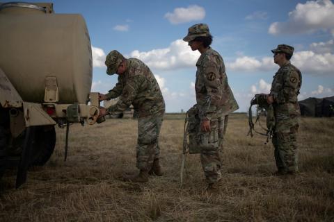 U.S. Army soldiers stand in line to get water at the Camp Donna military base along the United States - Mexico border in Donna, Texas, U.S., November 8, 2018. PHOTO BY REUTERS/Adrees Latif