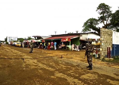 Soldiers from the Liberian army monitor a border checkpoint as part of Operation White Shield to control the Ebola outbreak, at an entrance to Bomi County in northwestern Liberia