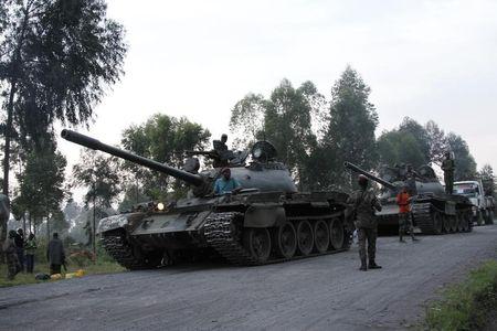 Soldiers from the Democratic Republic of Congo (DRC) arrive in tanks near the town of Kibumba at its border with Rwanda after fighting broke out in the Eastern Congo town, June 11, 2014. PHOTO BY REUTERS/Kenny Katombe