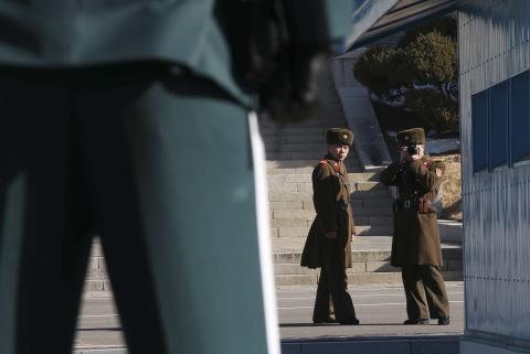 A North Korean soldier takes photographs of a South Korean soldier standing guard at the truce village of Panmunjom in the demilitarised zone (DMZ) separating North Korea from South Korea