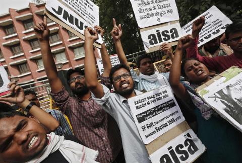 Students hold placards and shout slogans during a protest against the recent killings of two girls, in New Delhi