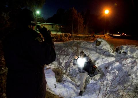 A man who claimed to be from Sudan, who kept saying "I just want to be safe", is confronted by a Royal Canadian Mounted Police (RCMP) officer as he illegally crosses the U.S.-Canada border leading into Hemmingford, Quebec, Canada, March 20, 2017. PHOTO BY REUTERS/Christinne Muschi