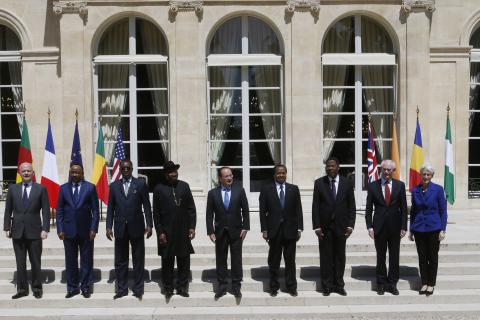 French President Francois Hollande (C) poses for a familly photo with (LtoR) Britain's Foreign Secretary William Hague, Niger's President Mahamadou Issoufou, Chad's President Idriss Deby, Nigerian President Goodluck Jonathan, Cameroon's President Paul Biya, Benin's President Thomas Yayi Boni, European Council President Herman Van Rompuy and U.S. Undersecretary of State for Political Affairs Wendy Sherman during a meeting at the Elysee Palace in Paris