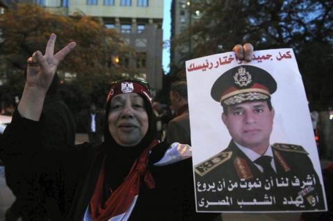 An Egyptian holds an image of Egypt's Army Chief General Abdel Fattah al-Sisi during a protest against what they say is Qatar's backing of ousted Egyptian president Mohamed Mursi's government, outside the Qatari Embassy in Cairo