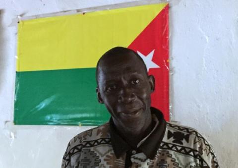 A supporter of the Movement of Democratic Forces for Casamance (MFDC) poses in front of a flag for Senegal's southern rebellion in Zinguinchor, Senegal, January 16, 2017. PHOTO BY REUTERS/Emma Farge