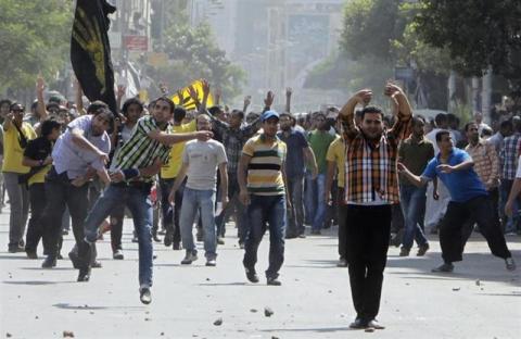 Supporters of deposed President Mohamed Mursi and the Muslim Brotherhood clash with anti-Mursi protesters during a march in Shubra street in Cairo