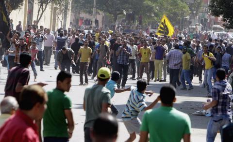 Supporters of deposed President Mohamed Mursi and the Muslim Brotherhood clash with anti-Mursi protesters during a march in Shubra street