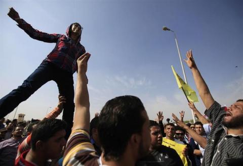 Supporters of the Muslim Brotherhood and ousted Egyptian President Mohamed Mursi shout slogans against the military and the Interior Ministry