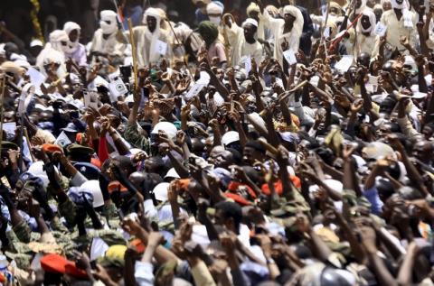 Supporters wave as Sudanese President Omar Hassan al-Bashir addresses the crowd during a war torn Darfur peace campaign rally in Al Ginana in West Darfur, April 2, 2016. PHOTO BY REUTERS/Mohamed Nureldin Abdallah