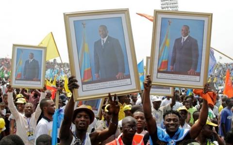 Supporters of Congolese President Joseph Kabila carry his portrait photographs during a pro-government rally in the Democratic Republic of Congo's capital Kinshasa, July 29, 2016. PHOTO BY REUTERS/Kenny Katombe