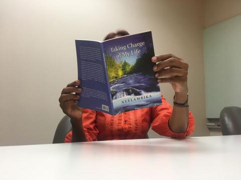 Neelambika, a marital rape survivor and women's rights campaigner, reads a section of her book in an office in Kuala Lumpur, Malaysia on March 13, 2019. PHOTO BY Thomson Reuters Foundation/Michael Taylor