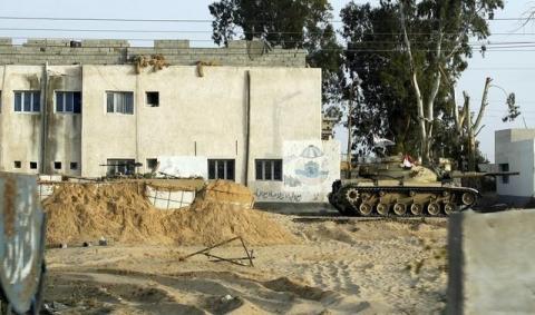 An Egyptian army tank is seen stationed outside a school taken over by soldiers in the Sinai Peninsula between the northern Sinai cities of Al-Arish and Sheikh Zuwayed, May 25, 2015. PHOTO BY REUTERS/Asmaa Waguih