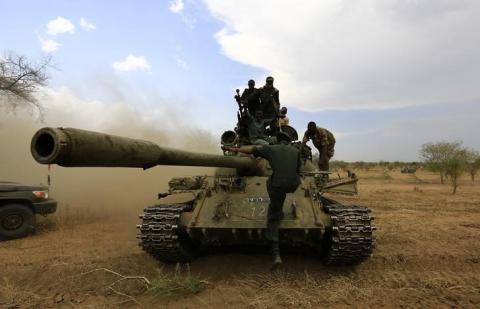 Military personnel are seen on a tank after the Sudanese Armed Forces (SAF) and the Rapid Support Forces (RSF) recaptured the Daldako area, outside the military headquarters in Kadogli, May 20, 2014. PHOTO BY REUTERS/Mohamed Nureldin Abdallah