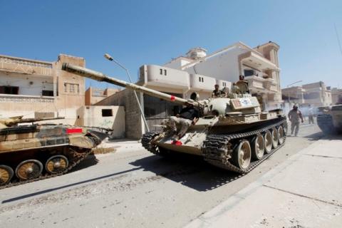 Libyan forces sit atop a tank after taking up new positions as they prepare for next advance against Islamic State holdouts in Sirte, Libya, August 29, 2016. PHOTO BY REUTERS/Ismail Zitouny