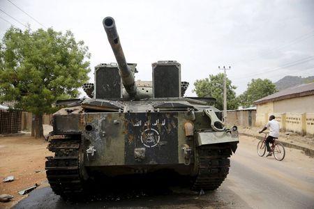 An armoured tank is seen abandoned along a road in Bazza town, after the Nigerian military recaptured it from Boko Haram, in Adamawa state, May 10, 2015. PHOTO BY REUTERS/Akintunde Akinleye