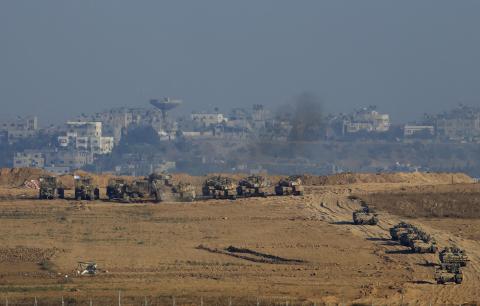 Israeli army tanks and armoured vehicles are seen in Gaza near the border with Israel