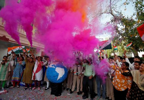 Teachers and students release coloured smoke as they celebrate after India shot down one of its satellites in space with an anti-satellite missile in a test, inside their school premises in Ahmedabad, India, March 27, 2019. PHOTO BY REUTERS/Amit Dave