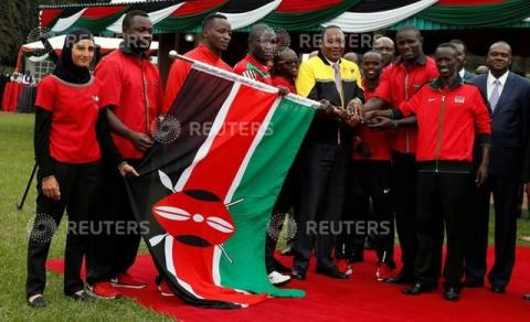 Kenyan President Uhuru Kenyatta (C) hands over the national flag to members of the Kenyan Olympics team from different sports disciplines at the State House in Nairobi, Kenya, July 22, 2016. PHOTO BY REUTERS/Thomas Mukoya