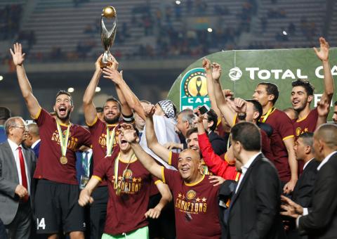 Esperance's Moez ben Cherifia and Haythem Jouini celebrate with the trophy after winning the CAF Champions League. PHOTO BY REUTERS/Zoubeir Souissi