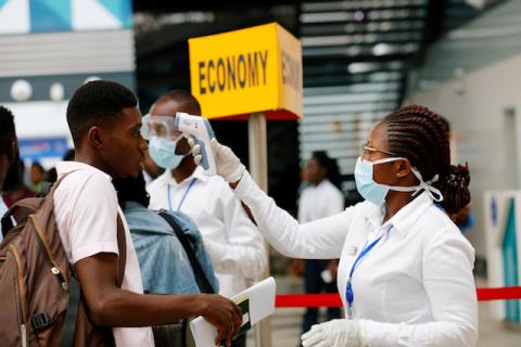 A health worker checks the temperature of a traveller as part of the coronavirus screening procedure at the Kotoka International Airport in Accra, Ghana, January 30, 2020. PHOTO BY REUTERS/Francis Kokoroko