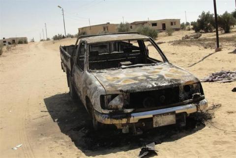 The wreckage of a burnt car after assaults on militant targets by the Egyptian Army