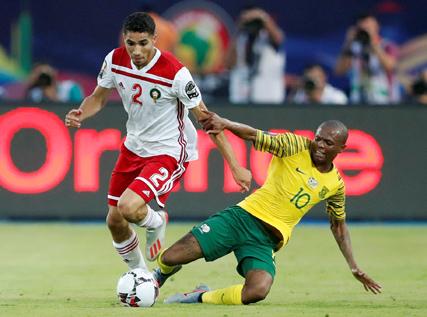 South Africa's Thulani Serero in action with Morocco's Achraf Hakim. PHOTO BY REUTERS/Amr Abdallah Dalsh