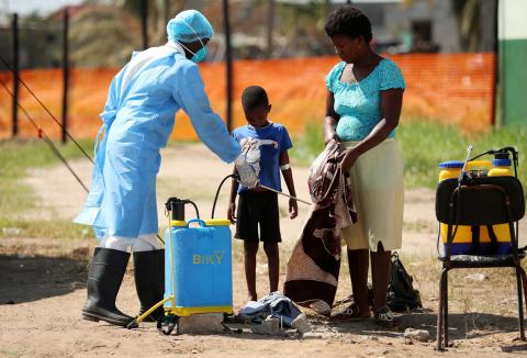 Medical staff spray disinfectant at a cholera treatment centre set up in the aftermath of Cyclone Idai in Beira, Mozambique, March 29, 2019. PHOTO BY REUTERS/Mike Hutchings