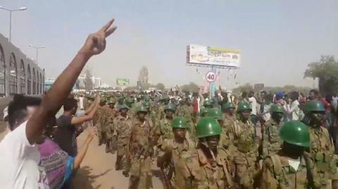 Demonstrators salute soldiers during a protest in Khartoum, Sudan April 10, 2019 in this still image taken from a video obtained from social media. PHOTO BY REUTERS/TWITTER/@THAWRAGYSD