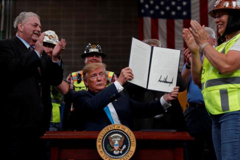 U.S. President Donald Trump displays an executive order he signed on energy and infrastructure at the International Union of Operating Engineers International Training and Education Center in Crosby, Texas, U.S., April 10, 2019. PHOTO BY REUTERS/Carlos Barria