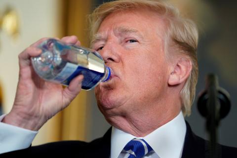 U.S. President Donald Trump takes a drink of water as he speaks about his recent trip to Asia in the Diplomatic Room of the White House in Washington, U.S., November 15, 2017. PHOTO BY REUTERS/Joshua Roberts