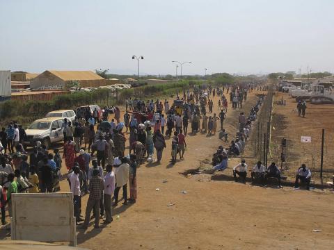 Civilians arrive to a shelter at the United Nations Mission in the Republic of South Sudan (UNMISS) compound on the outskirts of the capital Juba in South Sudan