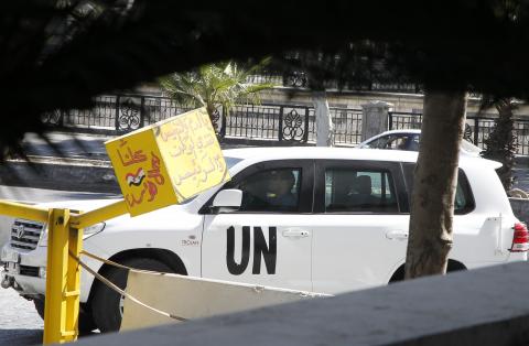 A U.N. vehicle returns to a hotel where experts from the Organisation for the Prohibition of Chemical Weapons (OPCW) are staying, in Damascus