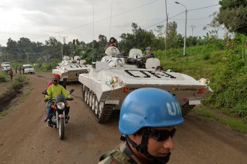 Congolese men ride on a motorcycle past peacekeepers from India, serving in the United Nations Organization Stabilization Mission in the Democratic Republic of the Congo (MONUSCO), as they drive on patrol in the town of Kiwanja, Democratic Republic of Congo, October 19, 2018. PHOTO BY REUTERS/Oleksandr Klymenko