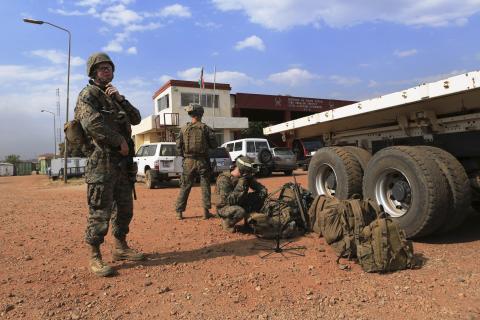 Sgt. John T. Kelly, (L) a radio operator with Special-Purpose Marine Air-Ground Task Force Crisis Response, calls in a status update during an evacuation of personnel from the U.S. Embassy in this handout photo taken in Juba