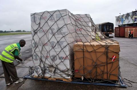 Workers offload the first consignment of U.S. Agency for International Development (USAID) medical equipment towards the fight against Ebola, at the Roberts International Airport in Monrovia