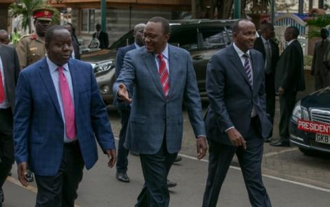 Kenya's President Uhuru Kenyatta (C) walks with Interior Cabinet Secretary Fred Matiangi and legislator Adan Duale before addressing the media outside his office in Nairobi Kenya, August 14, 2017. PHOTO BY REUTERS/Presidential Press Service