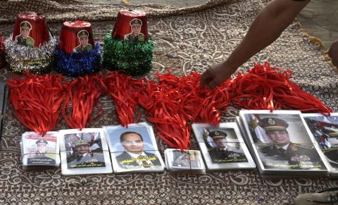 A street vendor sells memorabilia of former Egyptian army chief Abdel Fattah al-Sisi after his victory in presidential vote at Tahrir square in Cairo