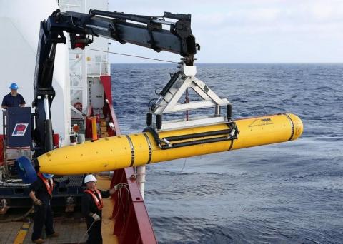 Crew aboard the Australian Defence Vessel Ocean Shield move the U.S. Navy's Bluefin-21 autonomous underwater vehicle into position for deployment in the southern Indian Ocean to look for the missing Malaysia Airlines flight MH370