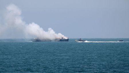 Smokes rises from an Egyptian coastguard vessel on the coast of northern Sinai, as seen from the border of southern Gaza Strip with Egypt, July 16, 2015. PHOTO BY REUTERS/Ibraheem Abu Mustafa