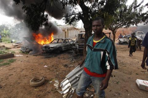 A man is pictured as he takes part in looting a mosque in Fouh district in Bangui