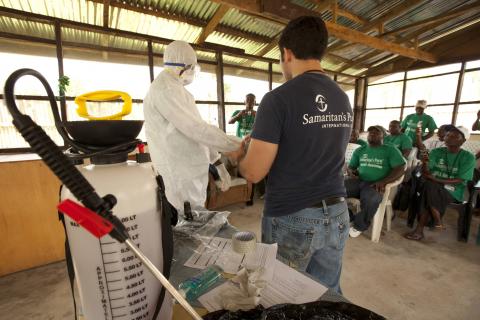 A Samaritan's Purse medical personnel demonstrates personal protective equipment to educate volunteers on the Ebola virus in Liberia