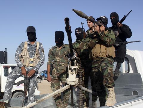 Shi'ite volunteers, who have joined the Iraqi army to fight against the predominantly Sunni militants from the radical Islamic State of Iraq and the Levant (ISIL), take part in a parade on a street in Kanaan, Diyala province