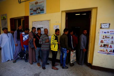 People wait to cast their votes during the second day of the referendum. PHOTO BY REUTERS/Amr Abdallah Dalsh