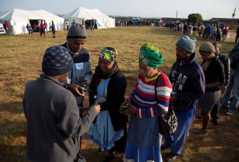 Election officials scan voters identity documents at a voting station during South Africa's local government elections in Umlazi, Durban, South Africa, August 3, 2016. PHOTO BY REUTERS/Rogan Ward