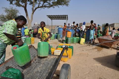 Displaced people, who fled from attacks of armed militants in town of Roffenaga, carry their jerrycans at the water point near UNHCR camp in Pissila, Burkina Faso, January 24, 2020. PHOTO BY REUTERS/Anne Mimault