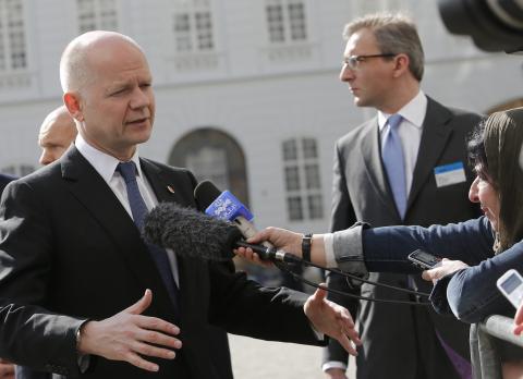 Britain's Foreign Secretary William Hague talks to journalists upon his arrival for a Council of Europe meeting in Vienna